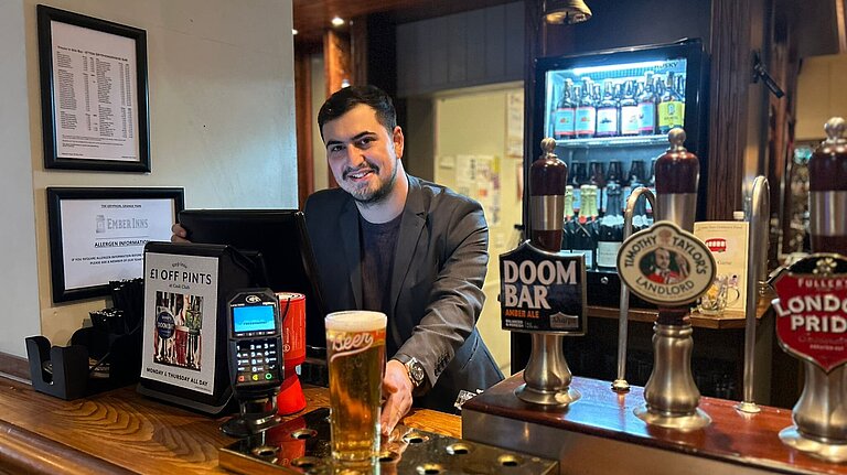 Guy Russo behind a pub bar.